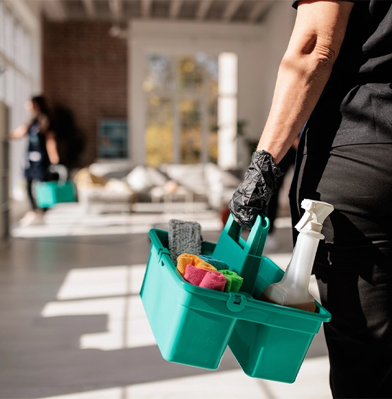 trusted-crime-scene Crime Scene Cleaners in Ottawa carry a spray bottle, and cleaning supplies in a home.